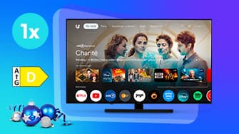 Smart-TV mit Streaming-Startbildschirm, der ein Banner mit vier Personen und eine Reihe von App-Symbolen auf blauem, festlichem Hintergrund mit Ornamenten anzeigt.