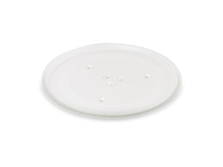 Drehteller für die Mikrowelle aus klarem Glas mit erhabener Mitte und kleinen Unebenheiten, isoliert auf weißem Hintergrund.